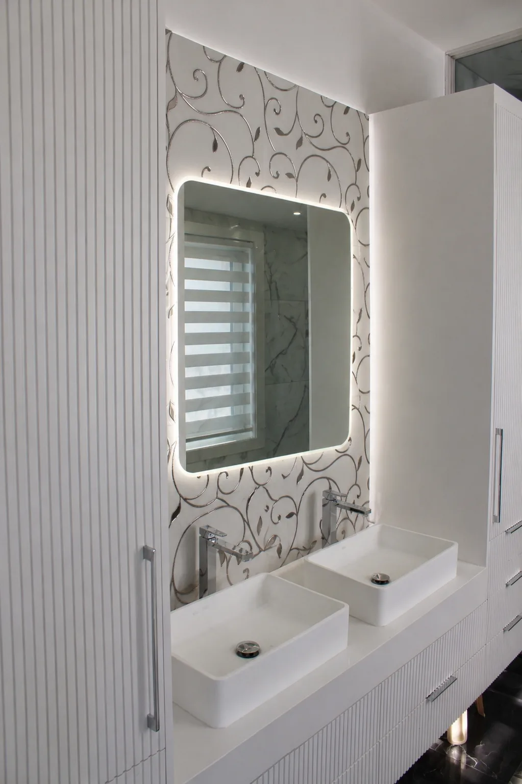 A sculptural bathtub, fluted vanity and decorative wall finish bring texture into this bathroom