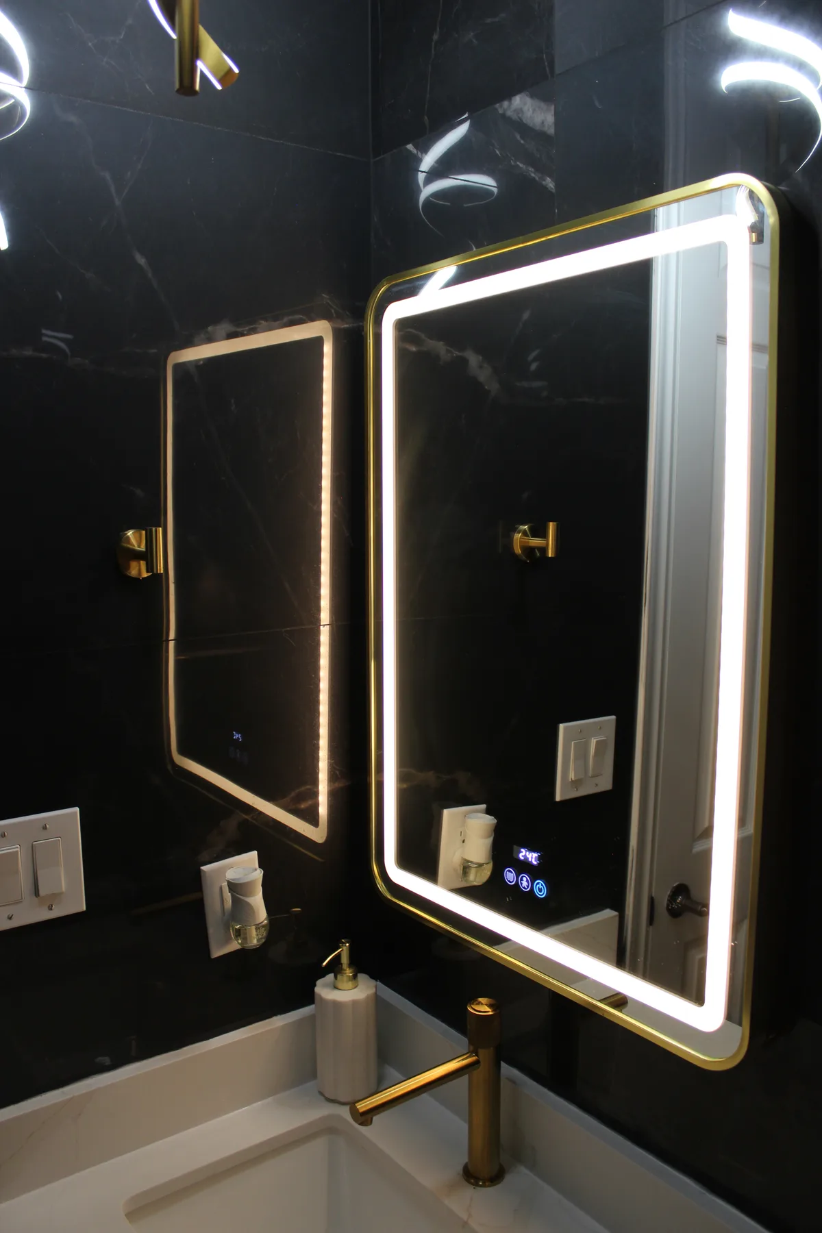 Dark surfaces and sculptural lighting make this powder room stand out